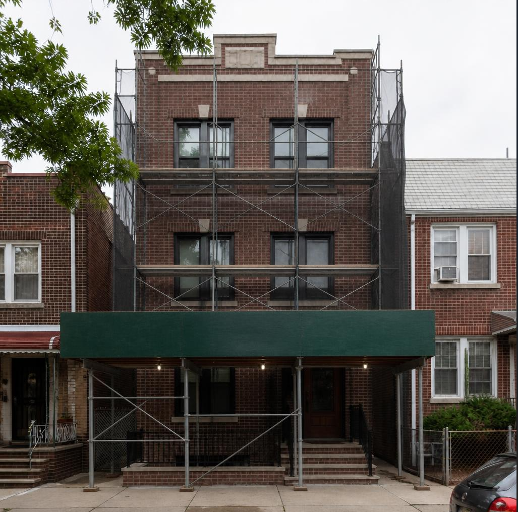 Middle Village facade during reconstruction with scaffolding and sidewalk protection