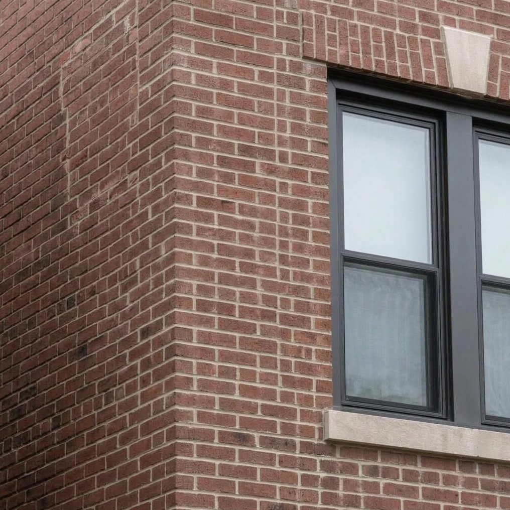 Repaired brick and mortar beside the same window in Middle Village