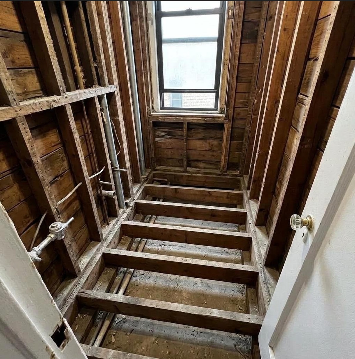 Windsor Terrace condo bathroom stripped to the exposed studs during renovation