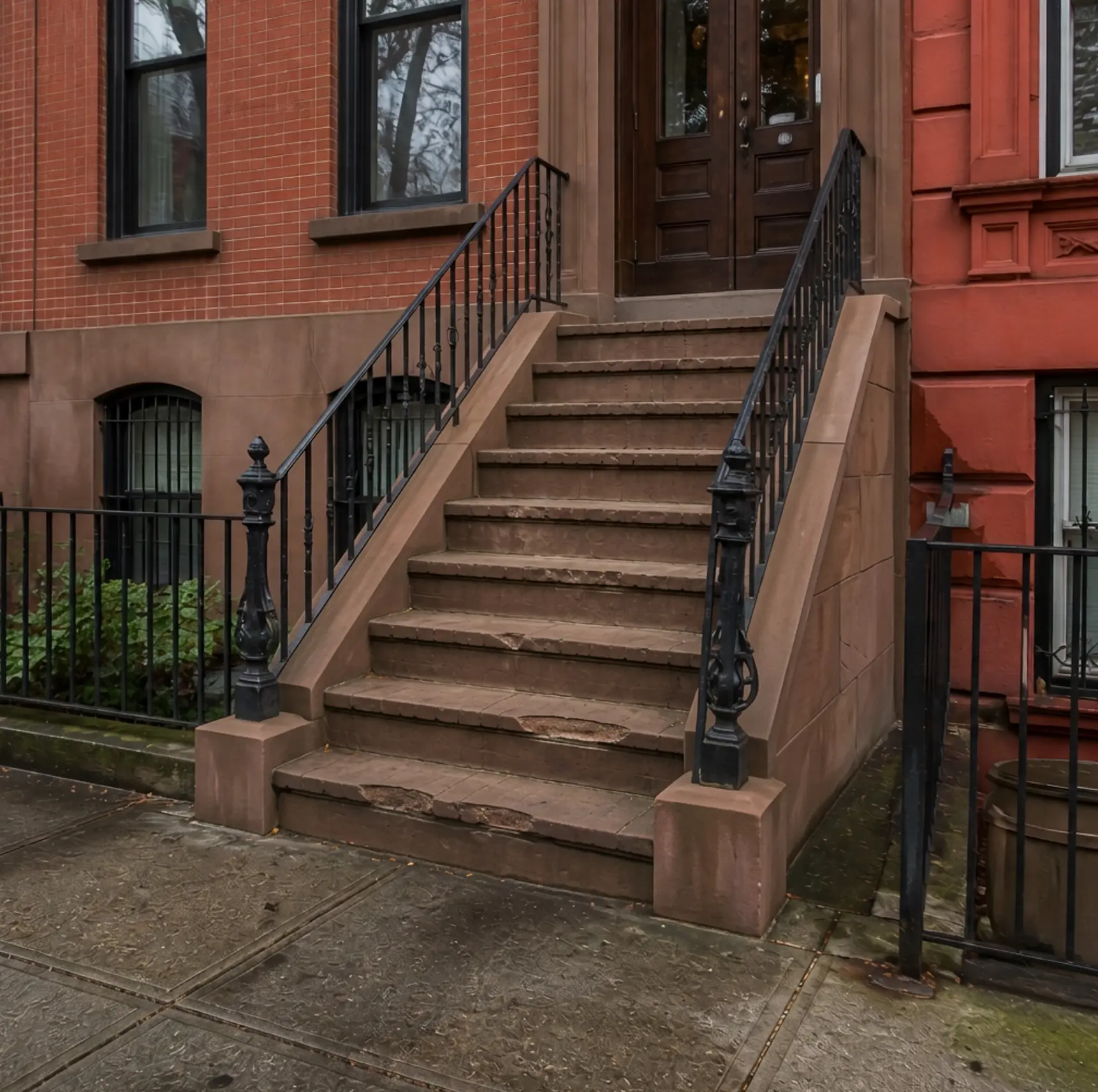 Deteriorated brick stoop before restoration at the Carroll Gardens project